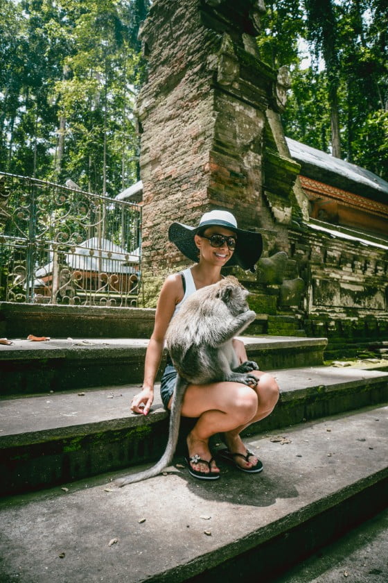Female on Vacation Having Fun with Monkey on Lap
